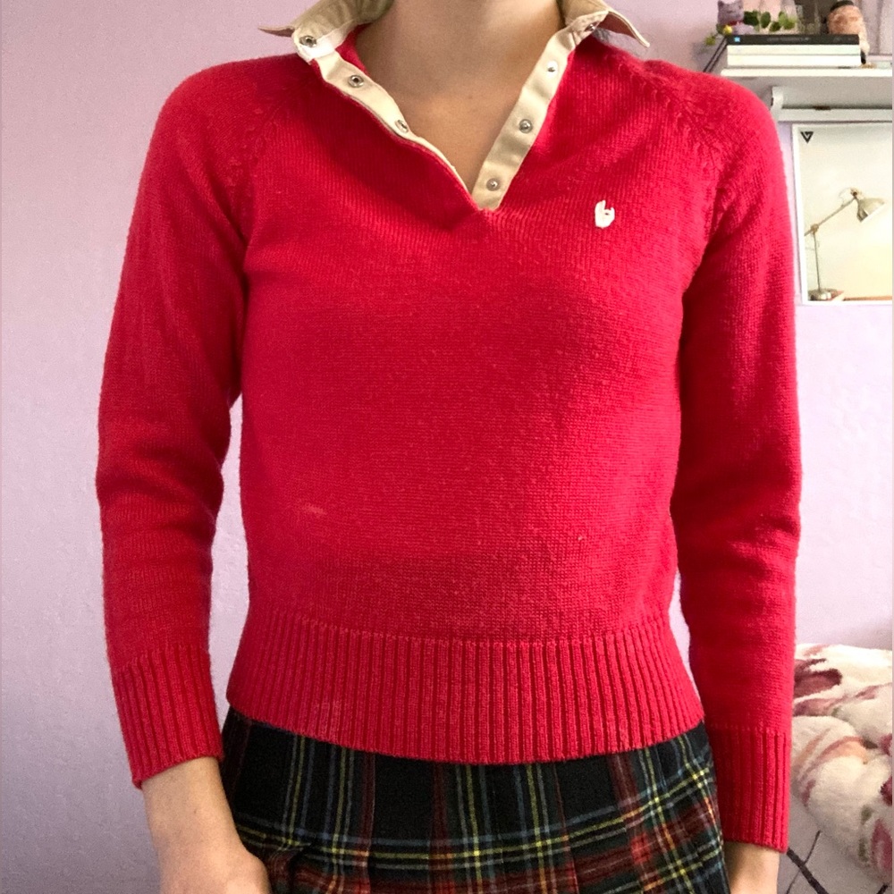 Red 100% acrylic sweater with tan collar and clasps.